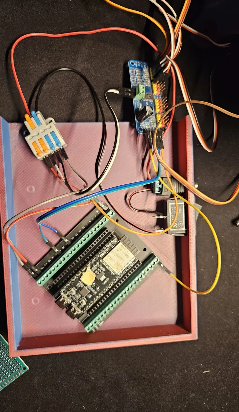 Control electronics: a dual-core ESP32-S3 on a screw-terminal breakout, the PCA9685 PWM driver (top), a buck converter and Wago connectors for servo power distribution.
